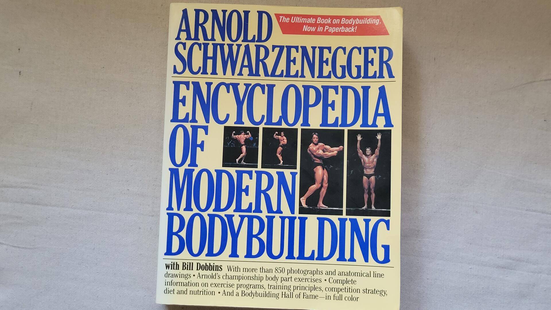 1980s vintage Encyclopedia of Modern Bodybuilding book by Arnold Schwarzenegger with Bill Dobbins. This first edition is collectible sports memorabilia and classic reference with more than 850 photographs and anatomical line drawings
