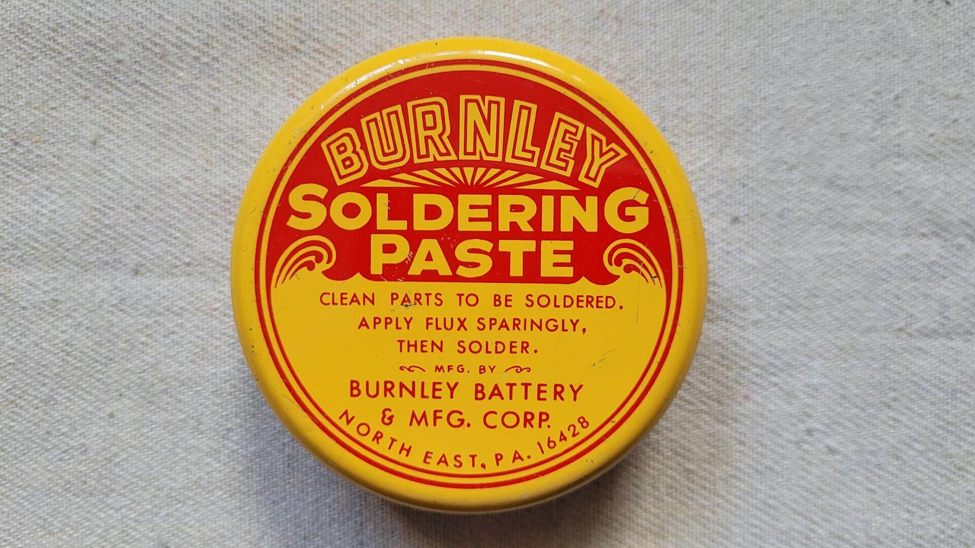 Brunley Battery & Mfg Co, North East Pennsylvania antique soldering paste 2 ounce yellow tin can with bold red lettering. Nice made in USA vintage collectible advertising container and beautiful early 20th century product and marketing design piece