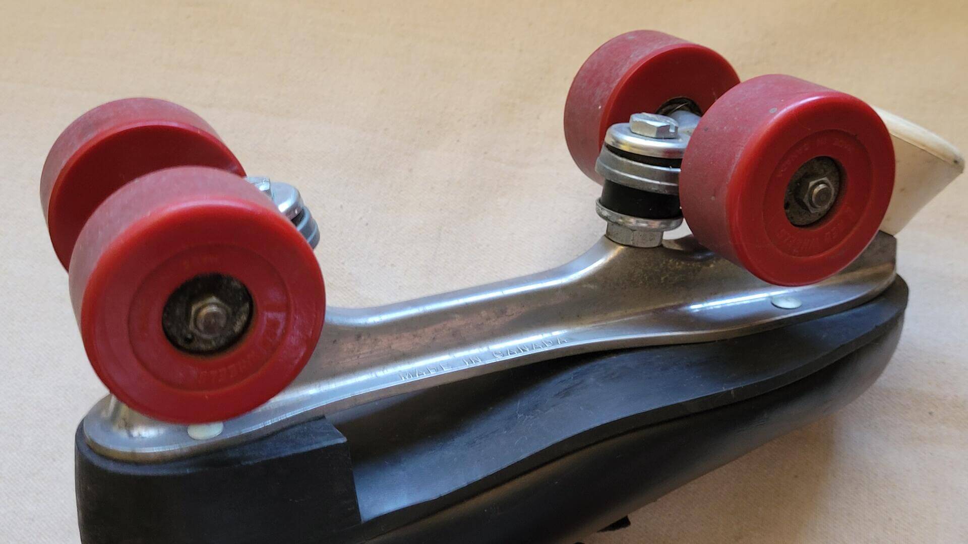 dominion-canada-marathon-rollers-skates-black-leather-red-wheels-cast=aluminum-frame-rare-vintage-canadiana-sports-equipment-and-memorabilia-wheels-view