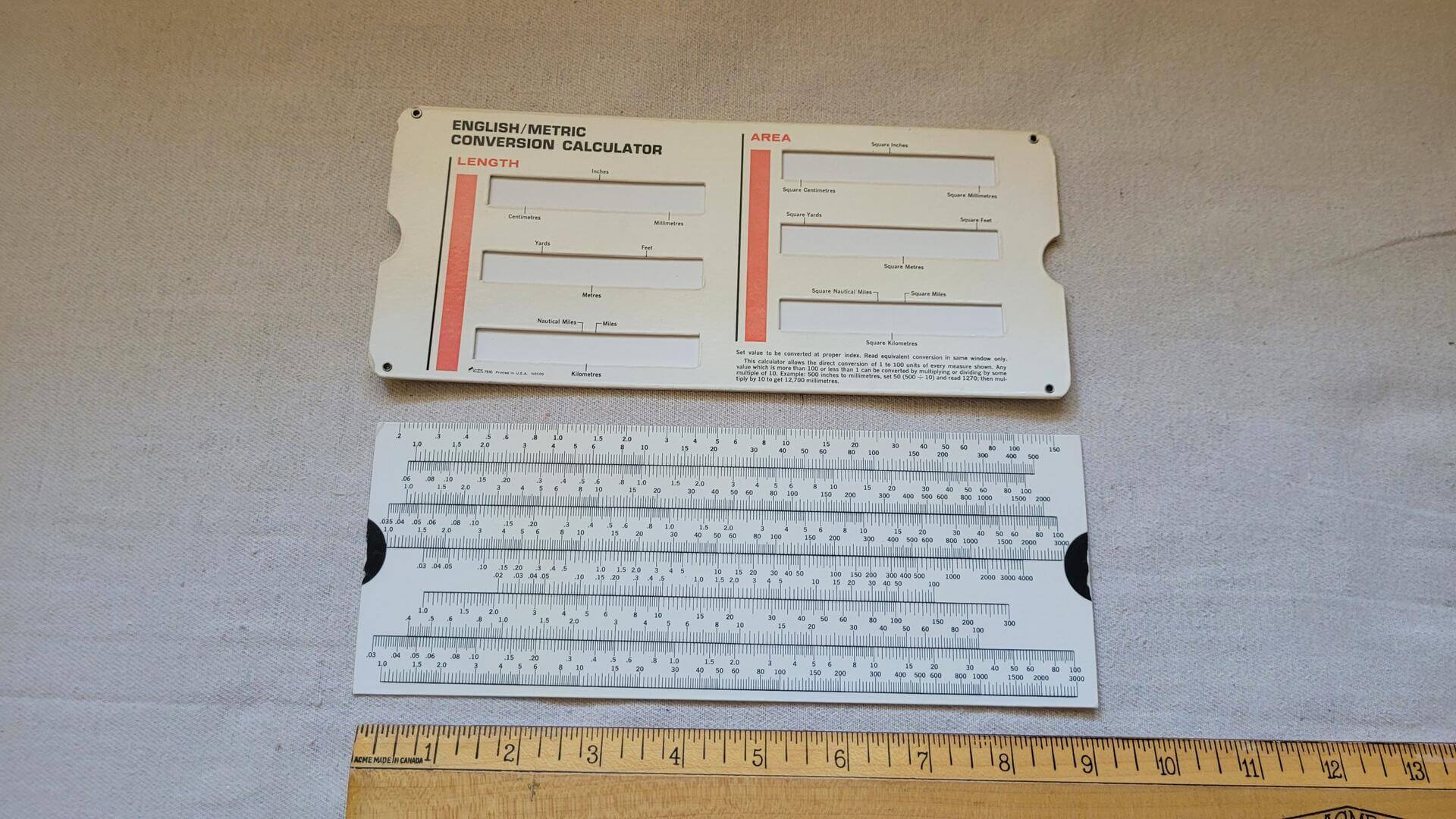 Vintage cardboard sliding English/Metric Conversion Calculator used for conversion of inches to cm, ounces to gallons, Liquid, Volume, Length, Area Equivalency Chart Case. 1970s antique made in USA collectible slide rule, retro office and school tools and supplies.