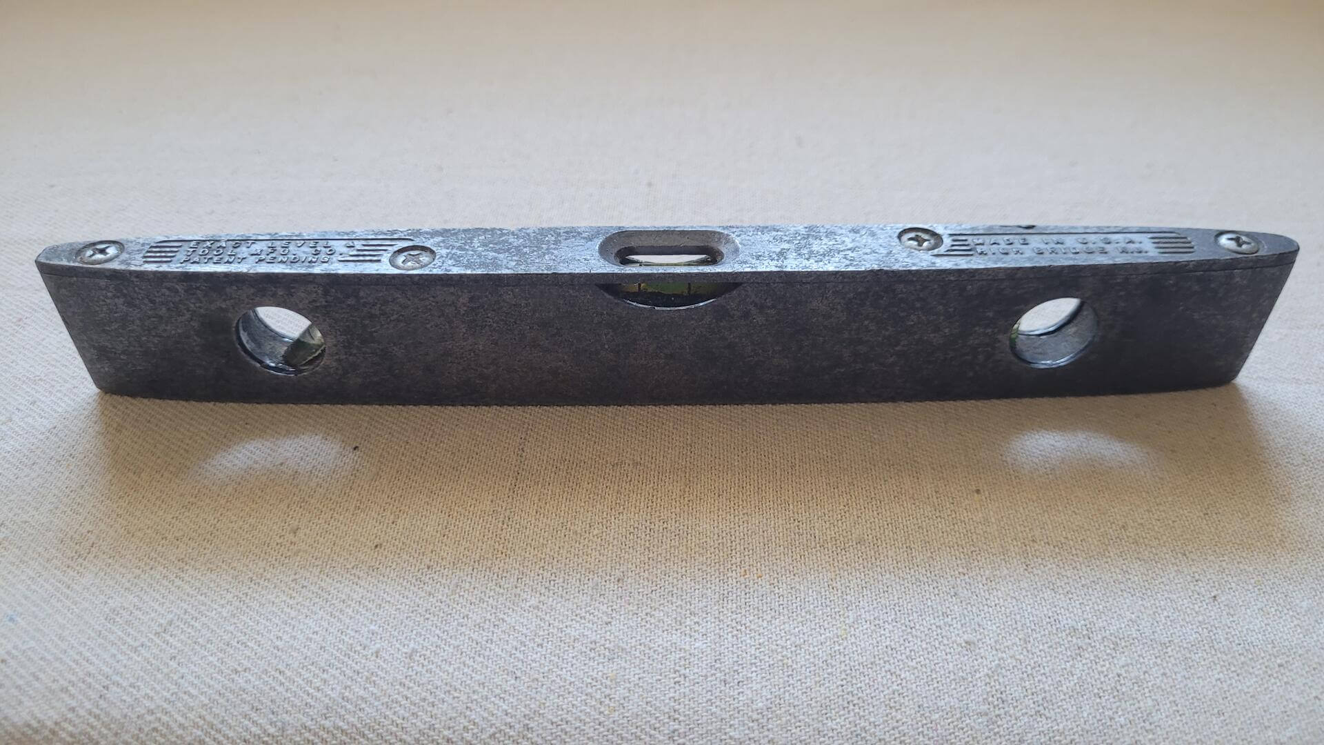 Antique cast aluminum torpedo level nince inches long by Exact Level & Tool Manufacturing Company from High Bridge NJ. Vintage made in USA collectible marking and measuring tools