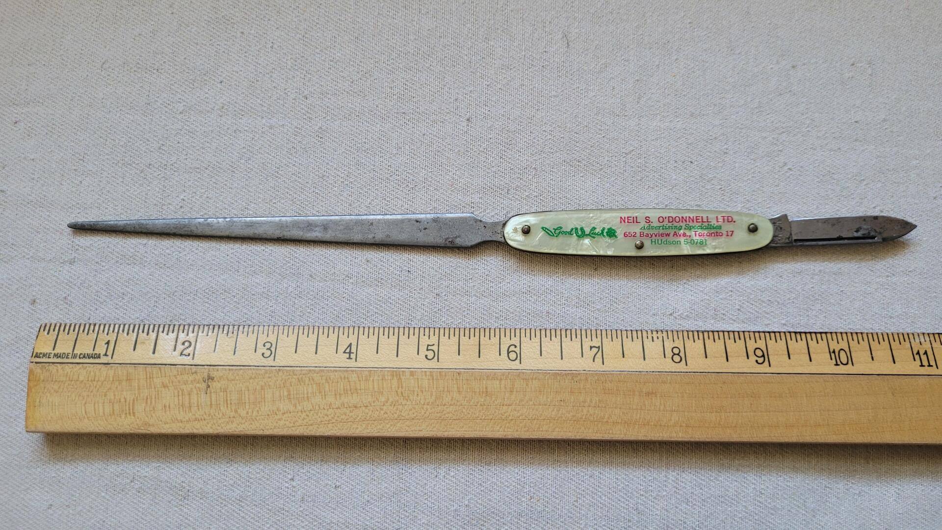 Vintage letter opener and folding knife combo sample by 1960s Neil S. O'Donnell Ltd Advertising Specialies company from Toronto. Vintage sleek design Canadiana office tool with some good luck charm and mid century Toronto's advertising business memorabilia