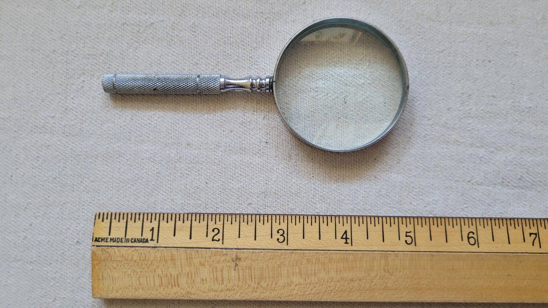 Vintage magnifying glass with knurled stainless steel handle 5 inches long with 2" lens. Antique collectible desktop office magnifier and visual aid tool