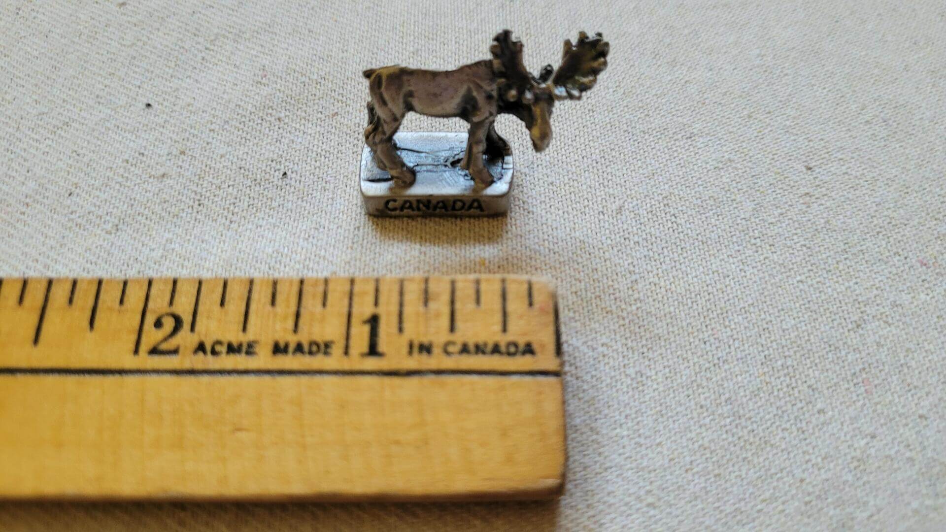 Miniature vintage pewter casting moose figurine sculpture one inch small with Canada engraving on the base
