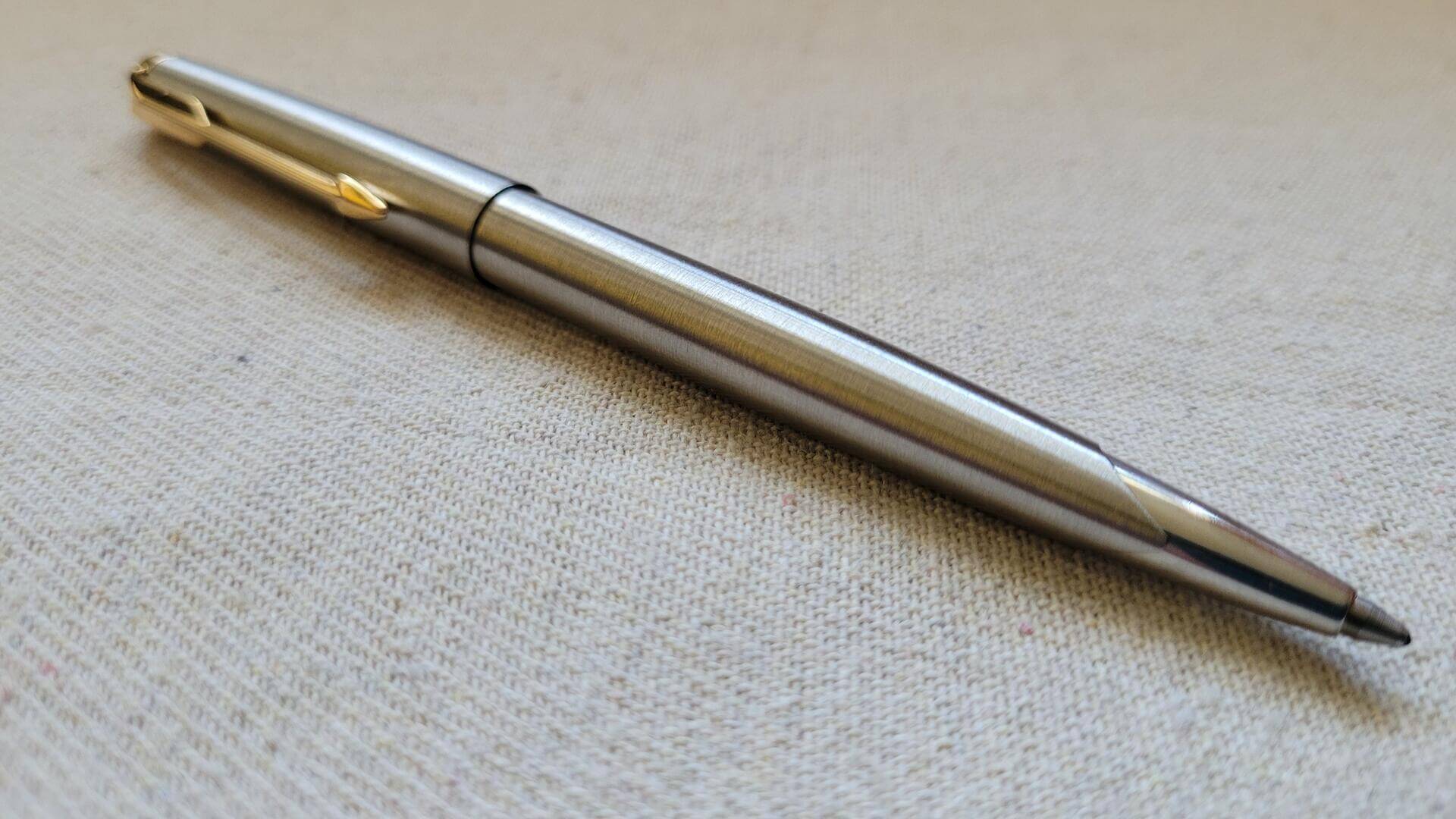 Beautiful classic chrome Parker Falcon cap actuated ballpoint pen with golden arrow clip and nice unique design transition from brushed barrel to polished steel tip. Rare vintage made in USA collectible writing equipment