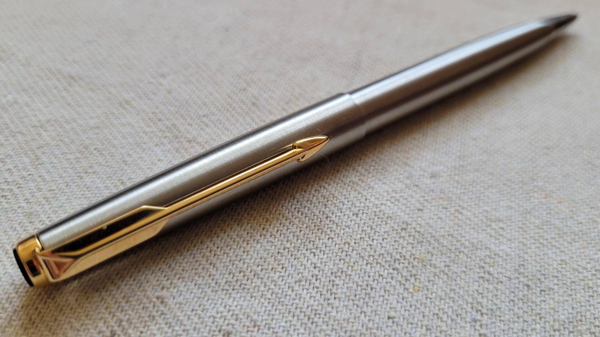 Beautiful classic chrome Parker Falcon cap actuated ballpoint pen with golden arrow clip and nice unique design transition from brushed barrel to polished steel tip. Rare vintage made in USA collectible writing equipment