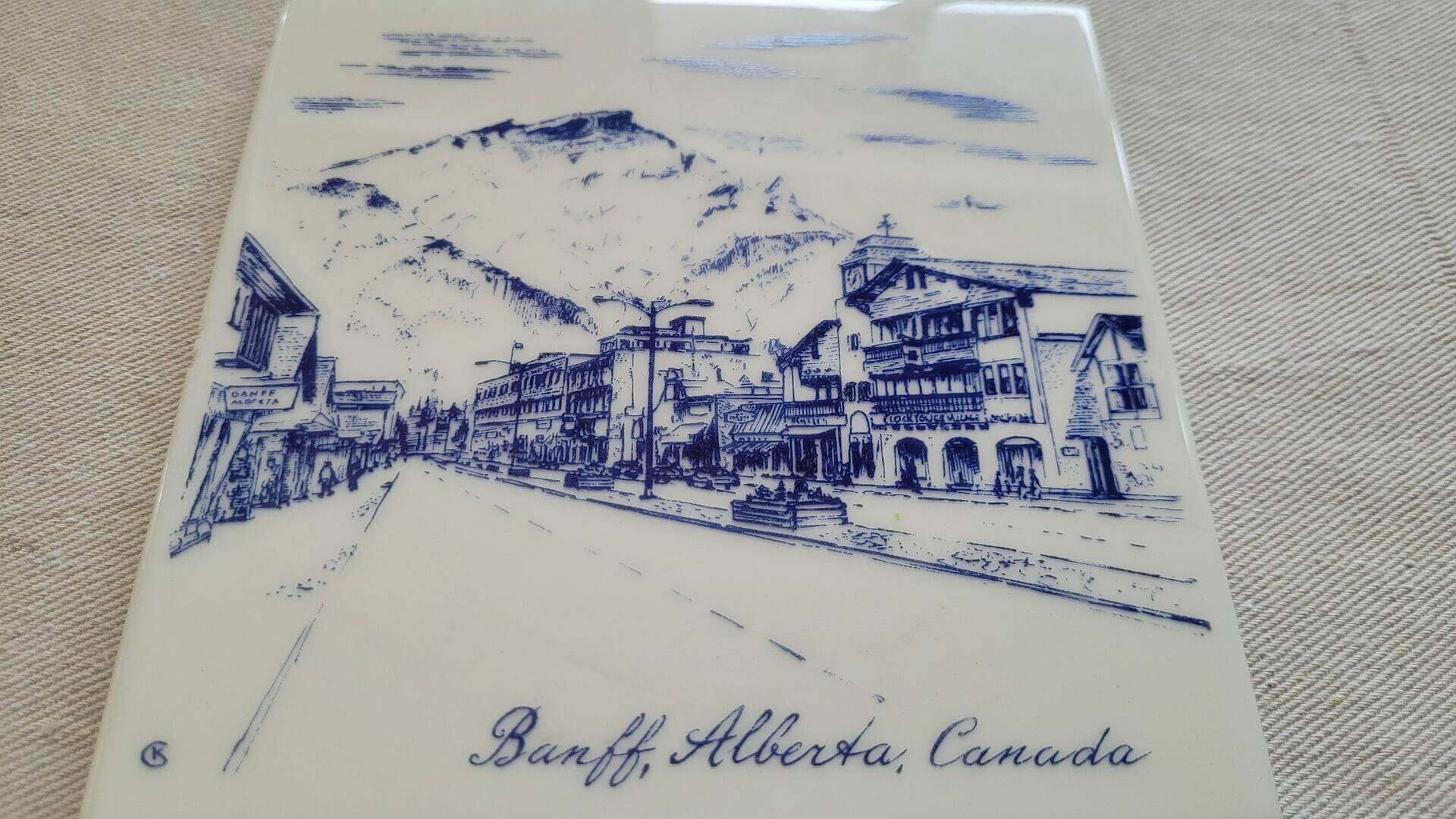 Vintage Banff Ave scenic downtown trivet tile with wall hook and pads. Rare custom design by Kantile Ceramics kiln fired heat proof perma finish Canadiana collectible ceramics