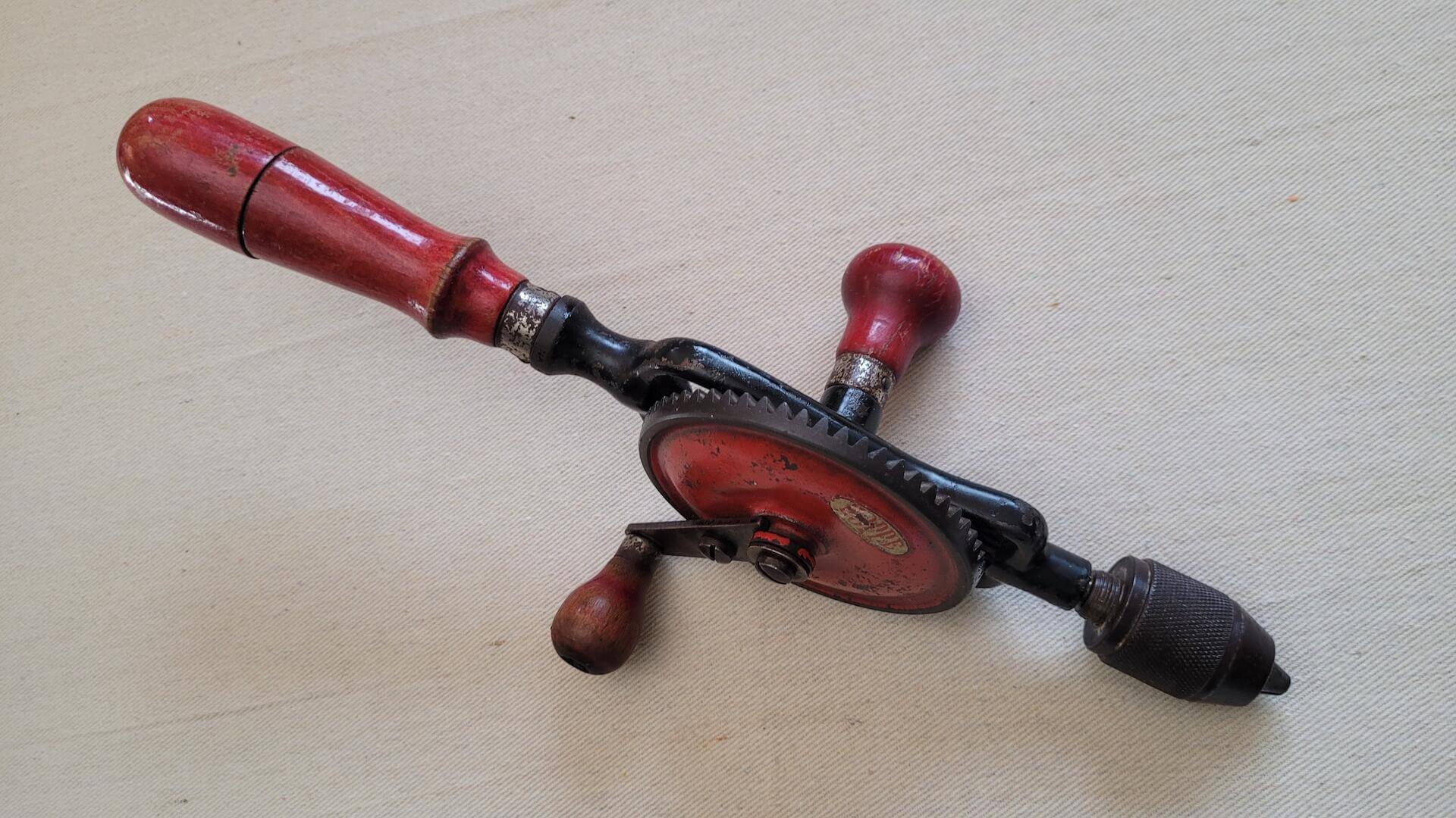 Vintage woodworking Hoppe egg beater style hand drill with red wooden handle. Rare antique made in Germany collectible carpentry hand tool