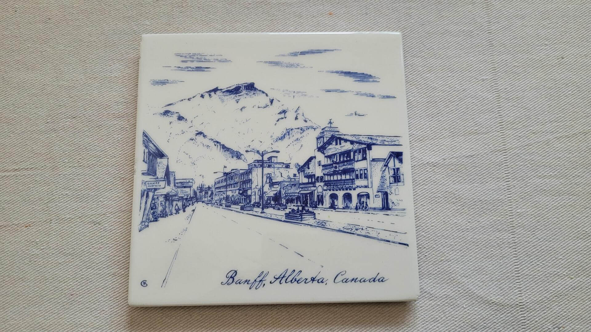 Vintage Banff Ave scenic downtown trivet tile with wall hook and pads. Rare custom design by Kantile Ceramics kiln fired heat proof perma finish Canadiana collectible ceramics