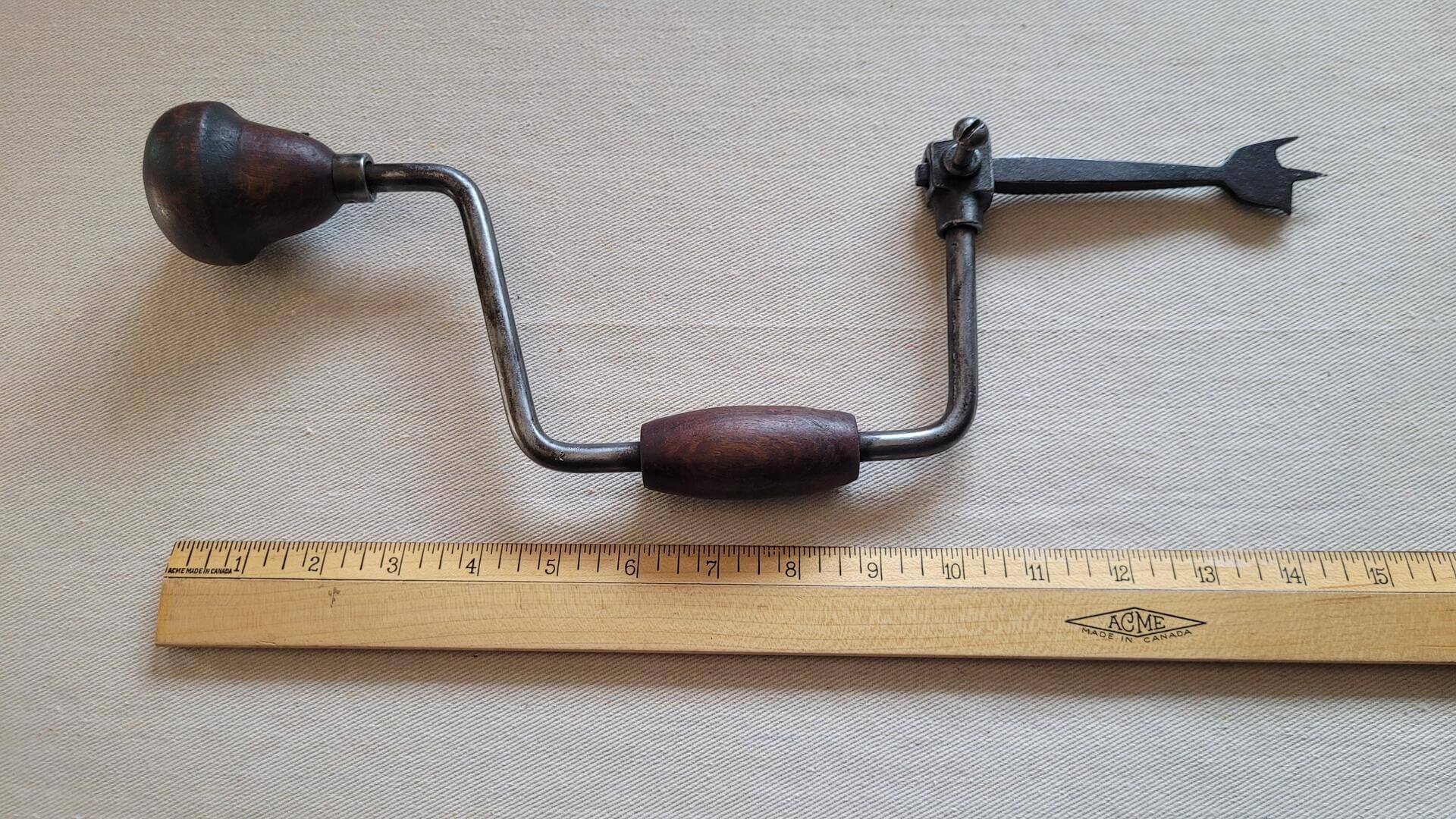 Antique woodworking bit brace hand drill with the original auger bit and hardwood handles. Vintage made in Germany collectible primitive carpentry and cabinet maker tool