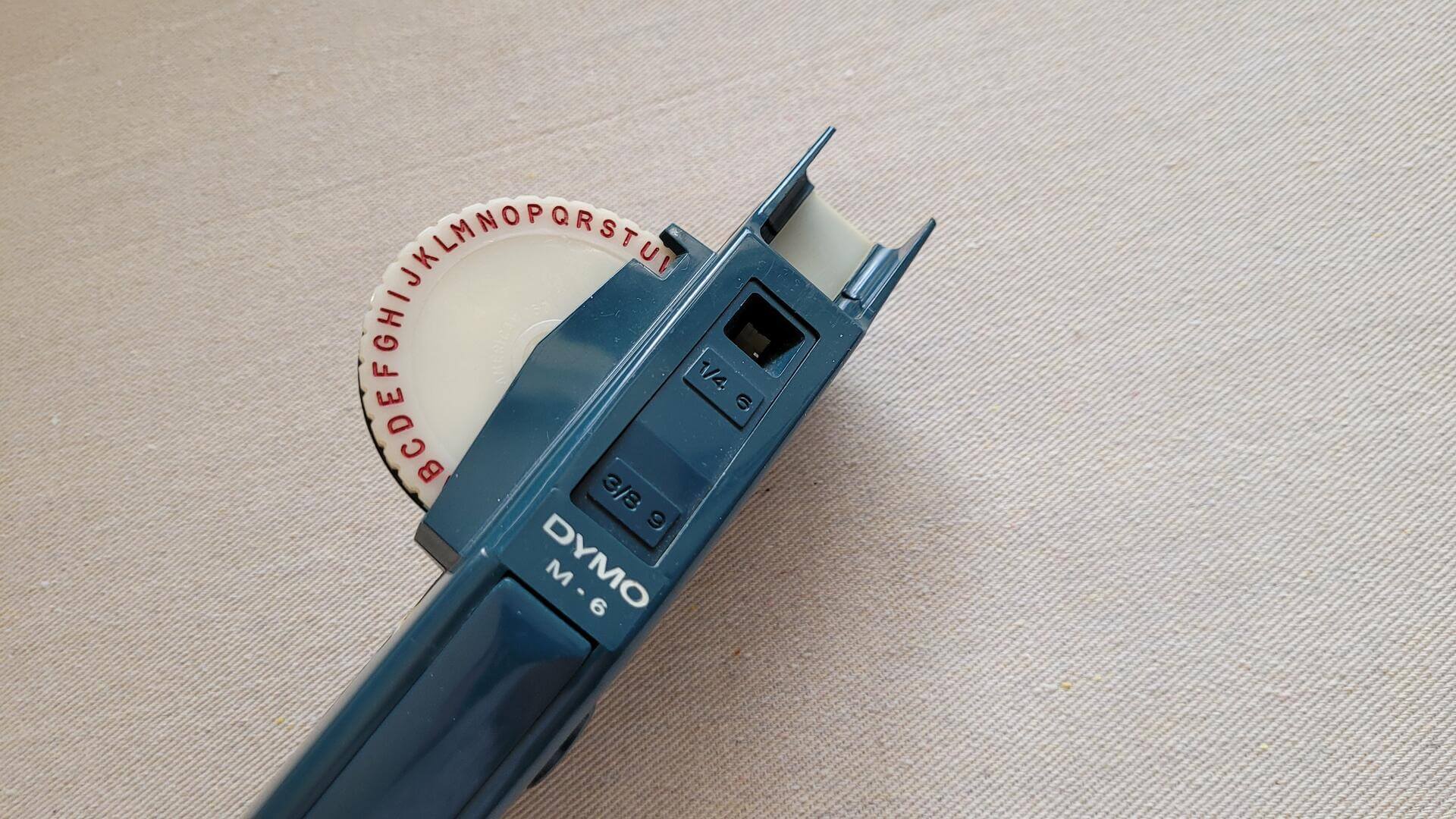ymo M-6 embossing label maker 1/4" and 3/8" tape writer with removable letters discs. Vintage made in USA collectible office equipment and tools