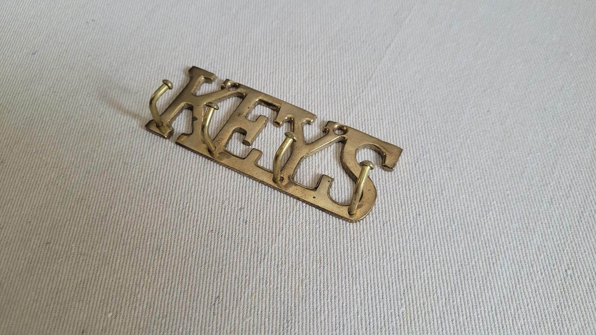 Vintage solid brass wall mount “KEYS” keyhook with holes for screws and 4 hooks to hang keys on. Retro collectible wall decor and house decorative accessories