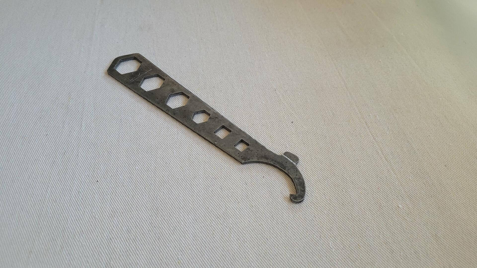 Antique L.C.N. 7 in 1 multi tool pot belly door closer wrench often mistaken and used as a bicycle spanner. Vintage made in USA collectible door hardware tools