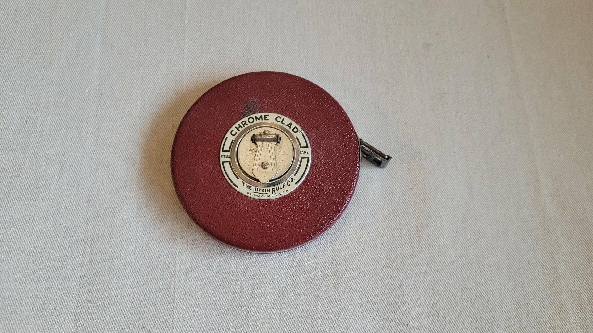 Vintage Lufkin Rule Co. 100' crome clad steel tape measure with Saginaw MI red leather case and Barrie ON chrome tape manufactured for Canadian market. Antique made in both USA and Canada collectible marking and measuring tool.