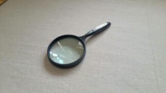 Reading magnifying glass with ergonomic curved handle, 3 inch lens, and original box. Vintage well designed and sturdy optical magnifier tool