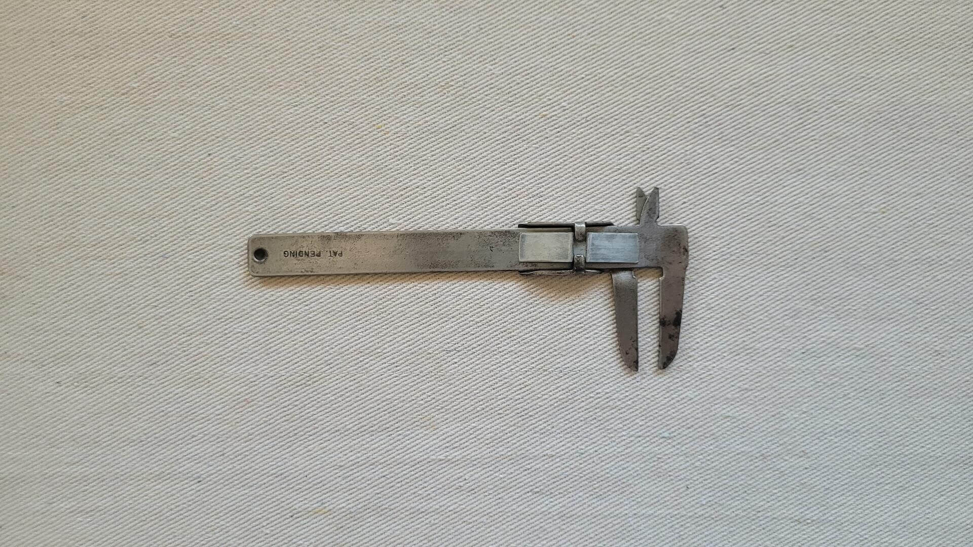 Pocket vernier caliper with imperial and metric scale. Vintage made in USA collectible marking and measuring machinist hand tools
