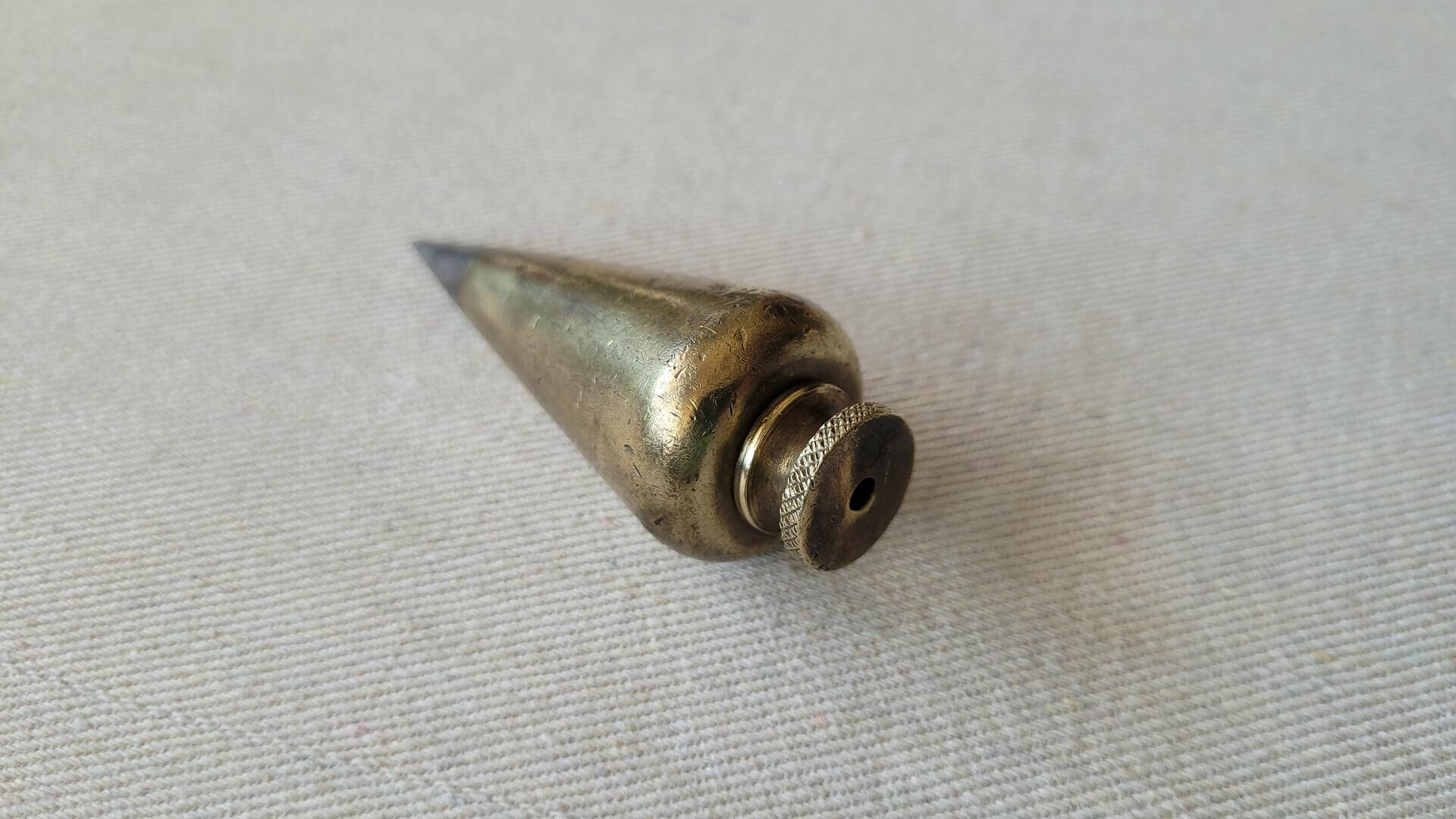 Beautiful antique turnip shaped solid brass plumb bob with the steel tip 5oz / 146g. Vintage marking and measuring collectible tools