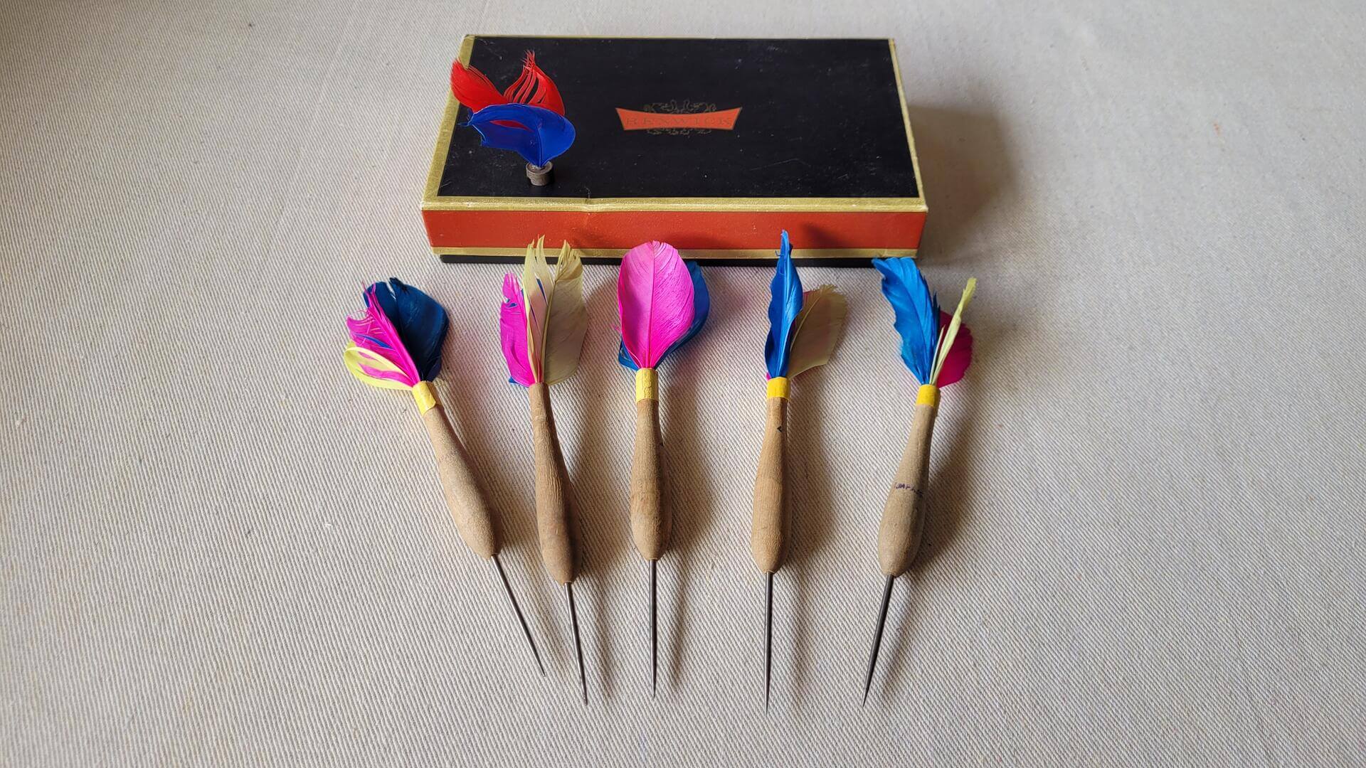 Rare set of 5 mid century wooden shafted natural feather darts with the steel tip. Vintage made in Japan collectible sporting goods & darts memorabilia