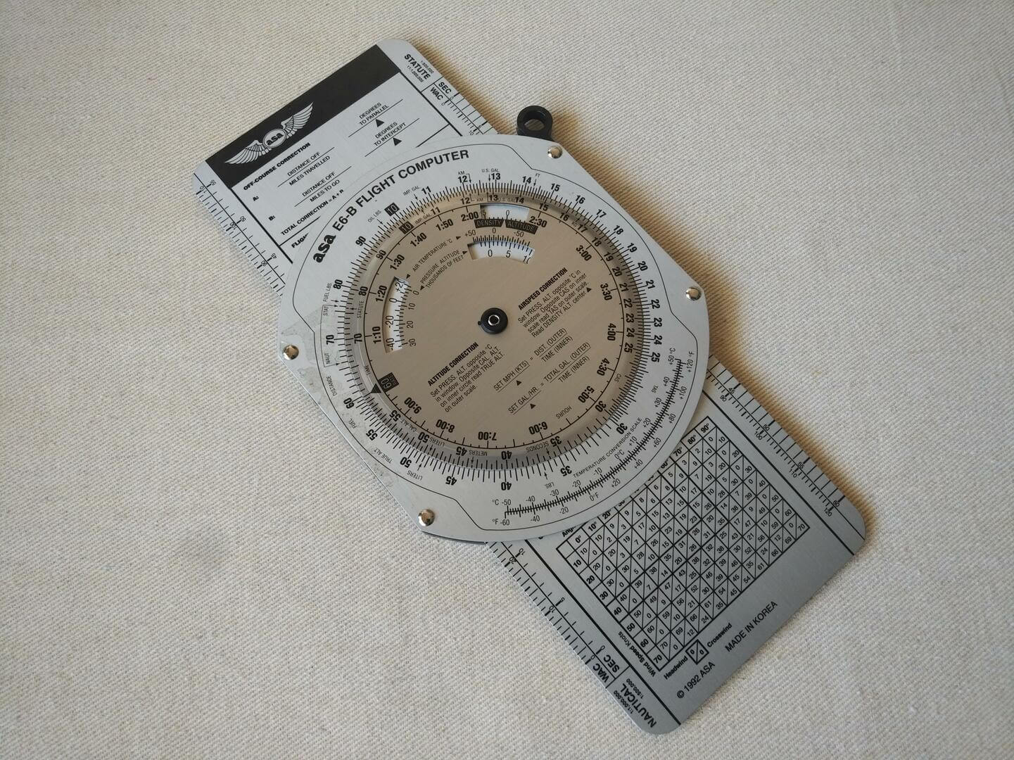 ASA Color E6-B solid aluminum manual flight computer slide-rule-style flight computer used for calculations and conversions for high-speed flight.