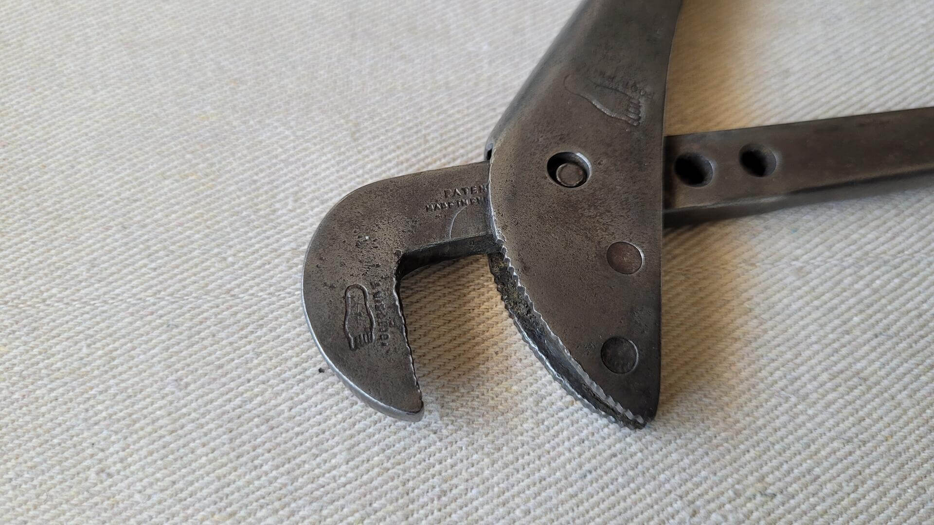 Antique Footprint Original Pattern adjustable pipe wrench spanner designed in 1875 with pin screw and slotted screwdriver end. Vintage made in Sheffield England collectible plumber, electrician, and pipe fitter gripping hand tools