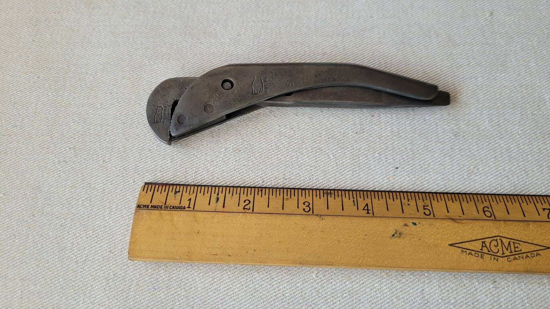 Antique Footprint Original Pattern adjustable pipe wrench spanner designed in 1875 with pin screw and slotted screwdriver end. Vintage made in Sheffield England collectible plumber, electrician, and pipe fitter gripping hand tools