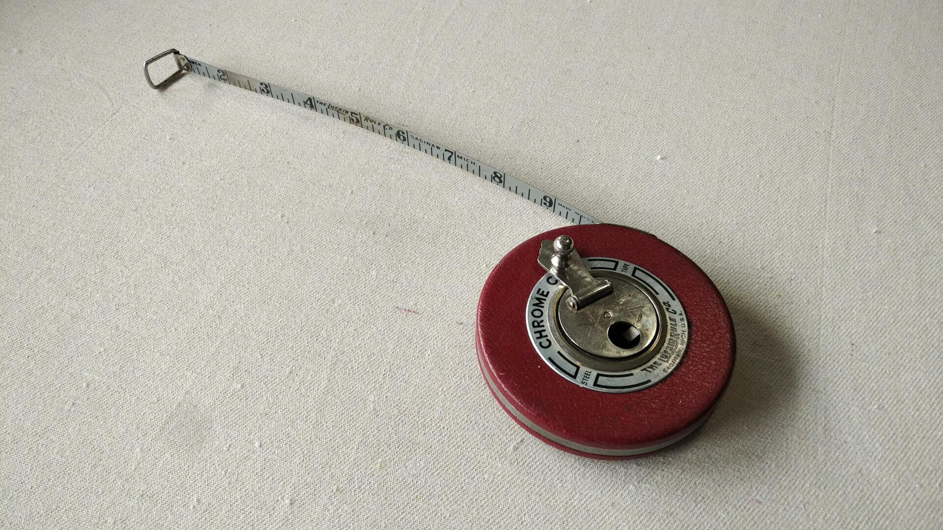 Nice vintage 50′ chrome clad steel tape measure by Lufkin Rule Co. from Saginaw, MI in red leather case. Antique made in both USA collectible marking and measuring tool. Note previous owner engraved name and address on the tape rim.