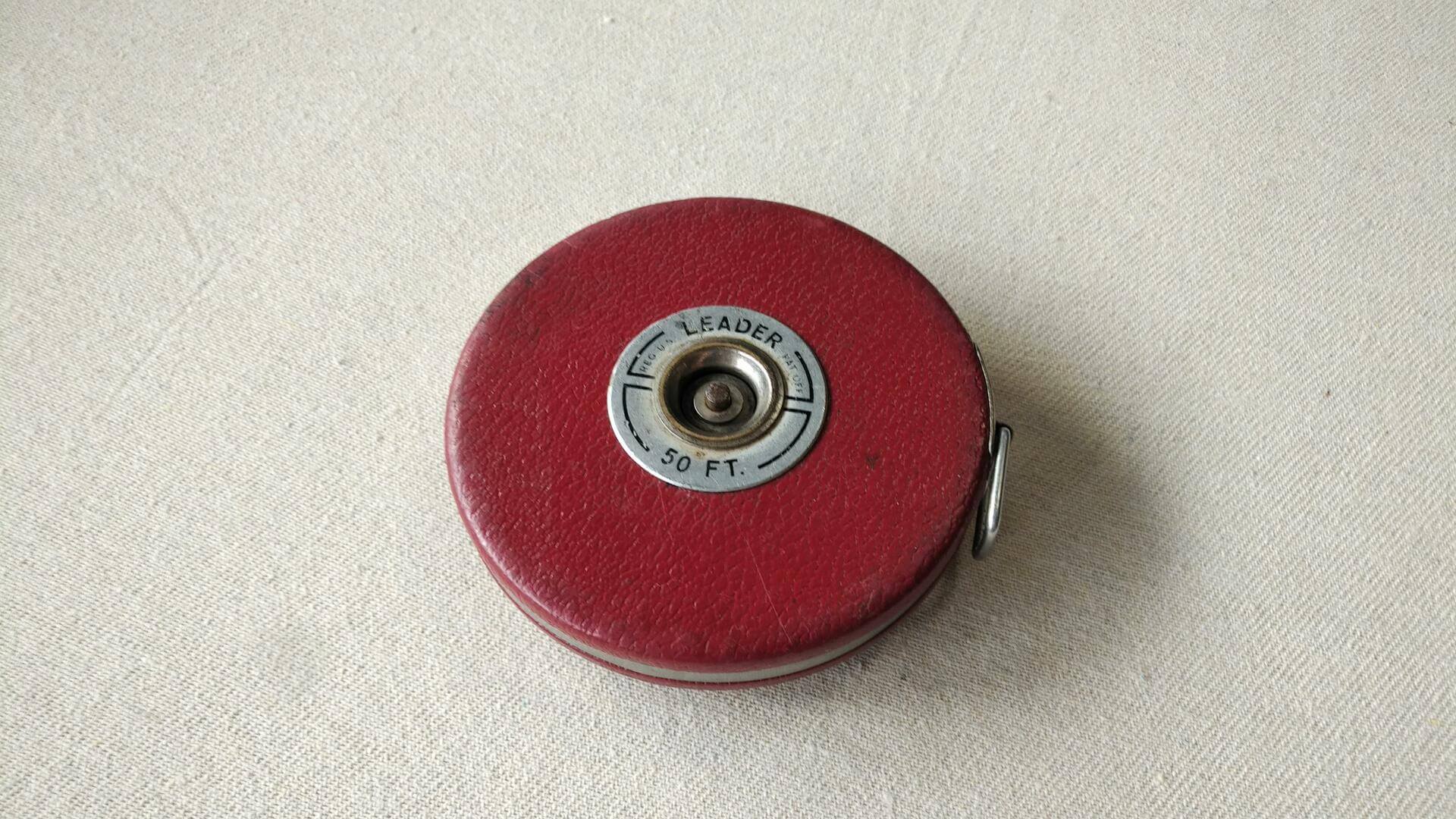 Nice vintage 50′ chrome clad steel tape measure by Lufkin Rule Co. from Saginaw, MI in red leather case. Antique made in both USA collectible marking and measuring tool. Note previous owner engraved name and address on the tape rim.