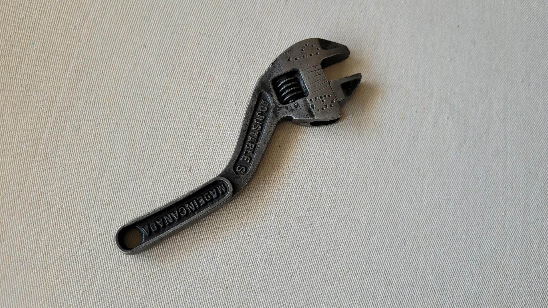 Rare antique 8 inch S curved adjustable wrench forged by McKinnon Industries from St. Catharines, Ontario. Vintage made in Canada collectible plumbing and automotive hand tools
