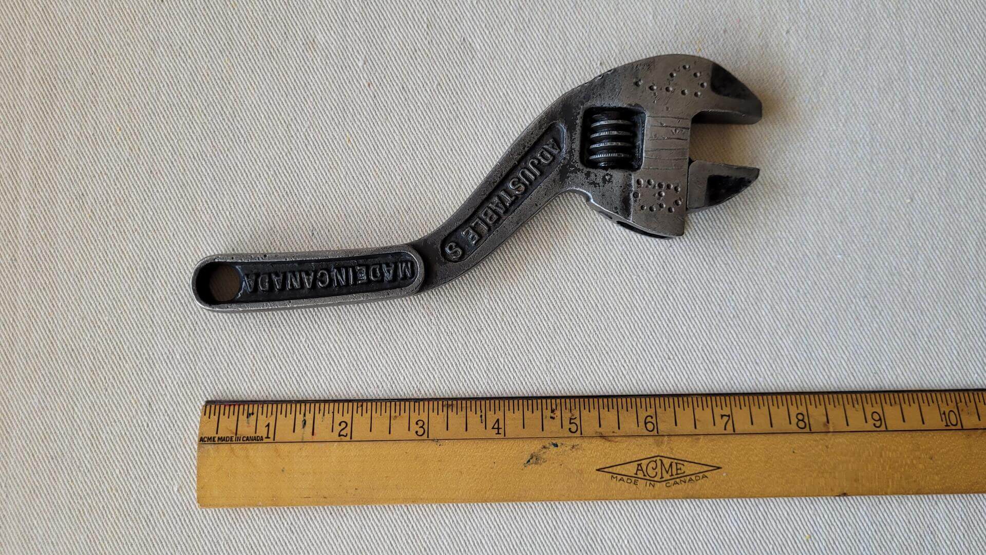 Rare antique 8 inch S curved adjustable wrench forged by McKinnon Industries from St. Catharines, Ontario. Vintage made in Canada collectible plumbing and automotive hand tools