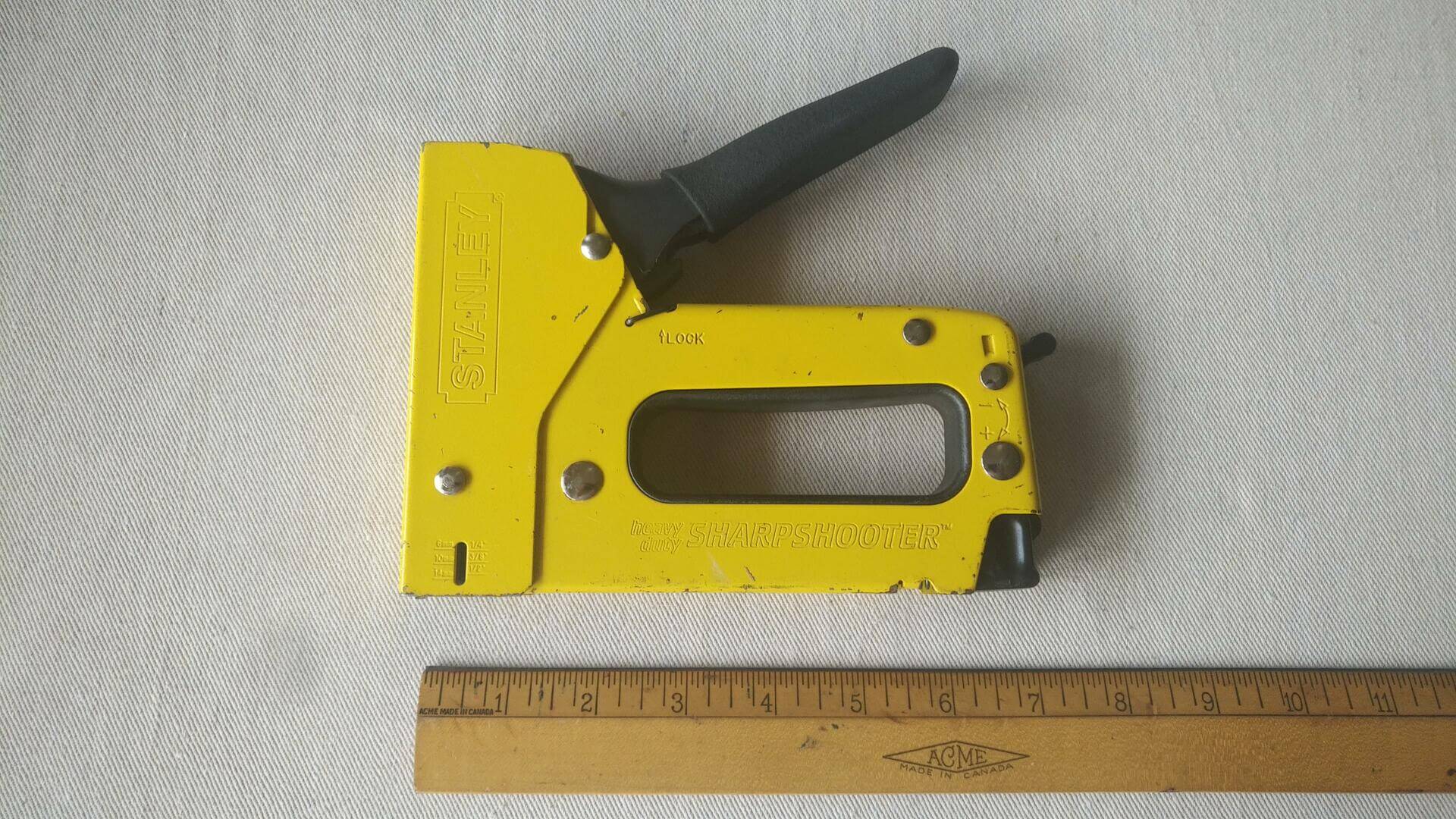 Rare vintage Stanley heavy duty Sharpshooter manual staple gun TR100 in yellow colour. Quality made in USA construction and upholstery nail and staple gun