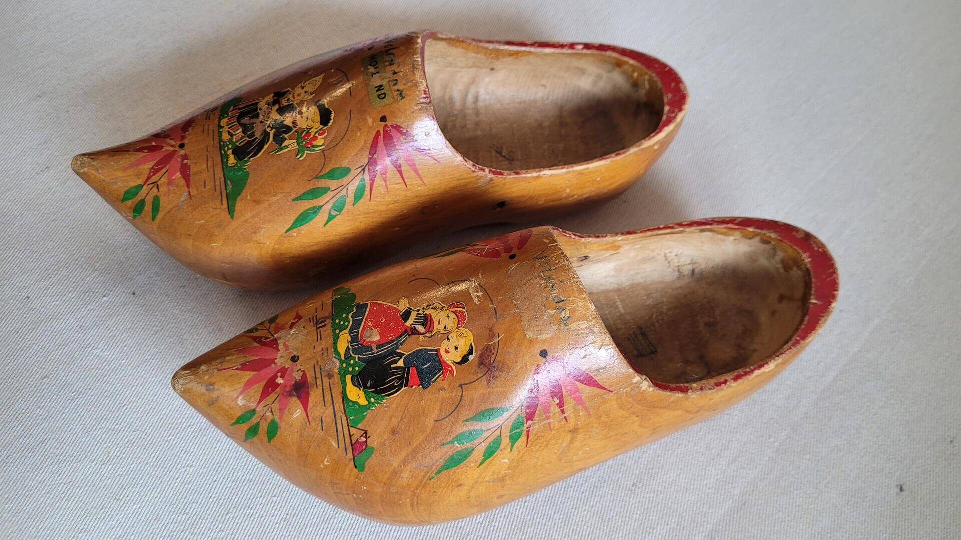 Nice vintage pair of hand painted wooden Dutch clogs with girls motif. Antique made in Holland collectible decorative hand made wood objects and art