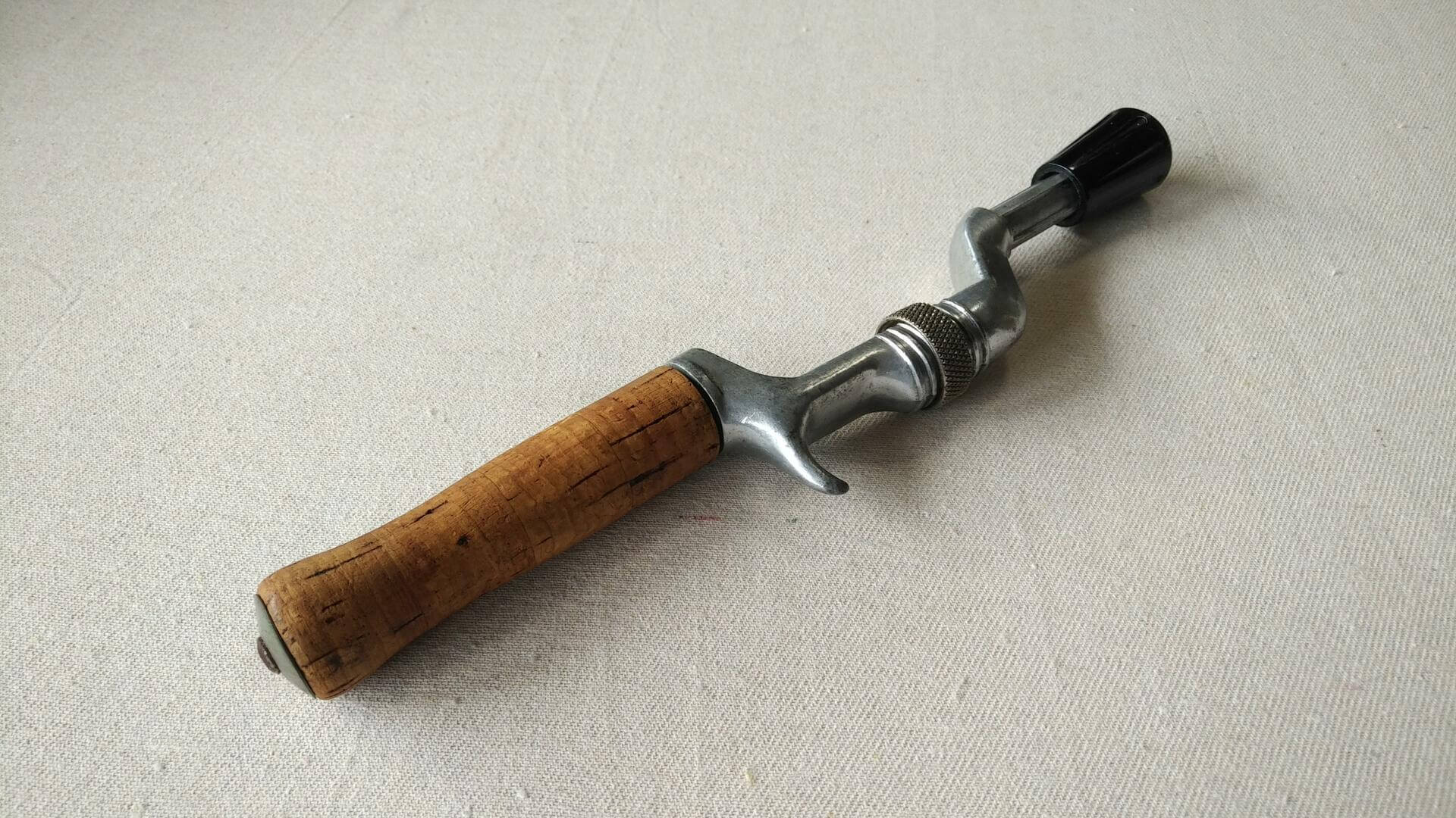 Vintage Dependun brand cast aluminum fishing rod handle with the cork handle. Mid century MCM collectible fishing and outdoors equipment and sporting goods