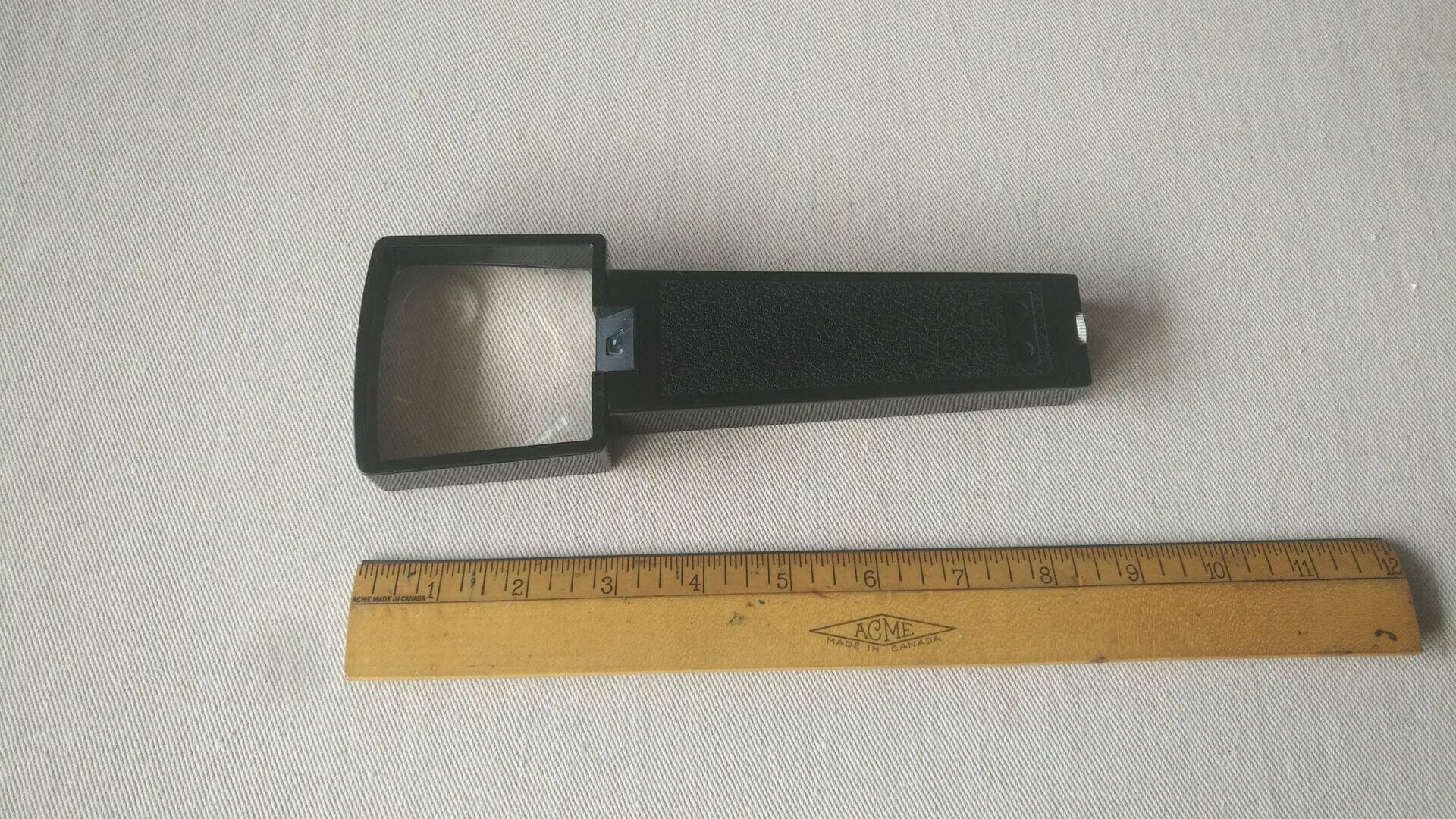 Lumagny illuminated handheld magnifier with dual lens battery operated. Vintage made in Hong Kong collectible magnifying glass and optical tools